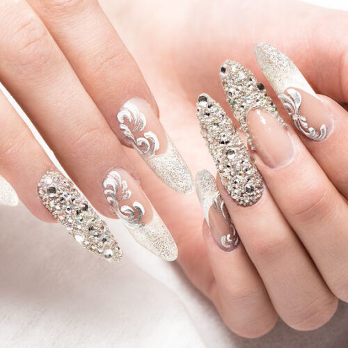 Beautifil wedding manicure for the bride in gentle tones with rhinestone. Nail Design. Close-up.
